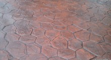 Stamped Concrete - Random Stone, Brick Red integral colour, Dark grey accent.